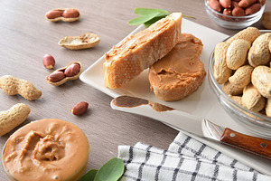 Delicious natural peanut butter spread on slices of bread, a Food & Drink Photo by Davizro's Market