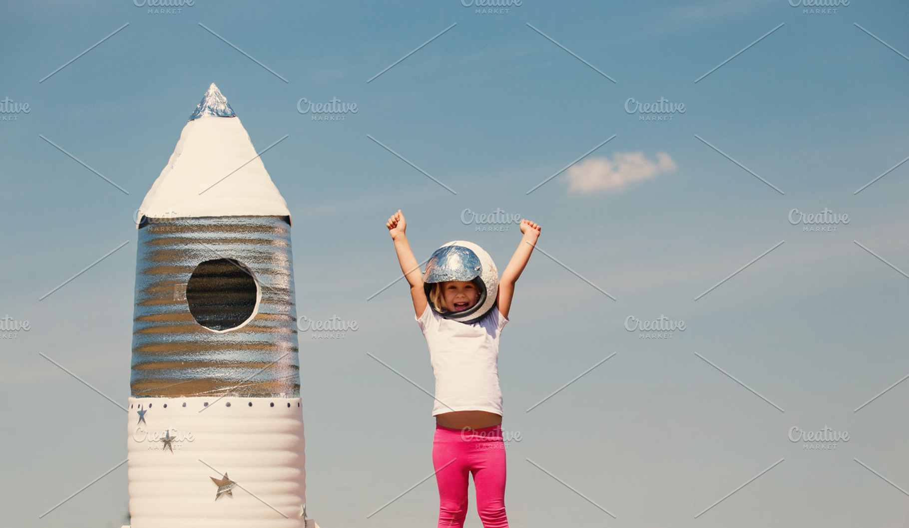 Happy child dressed in an astronaut costume playing with hand ma featuring, a Person Photo by Maksimkostenko