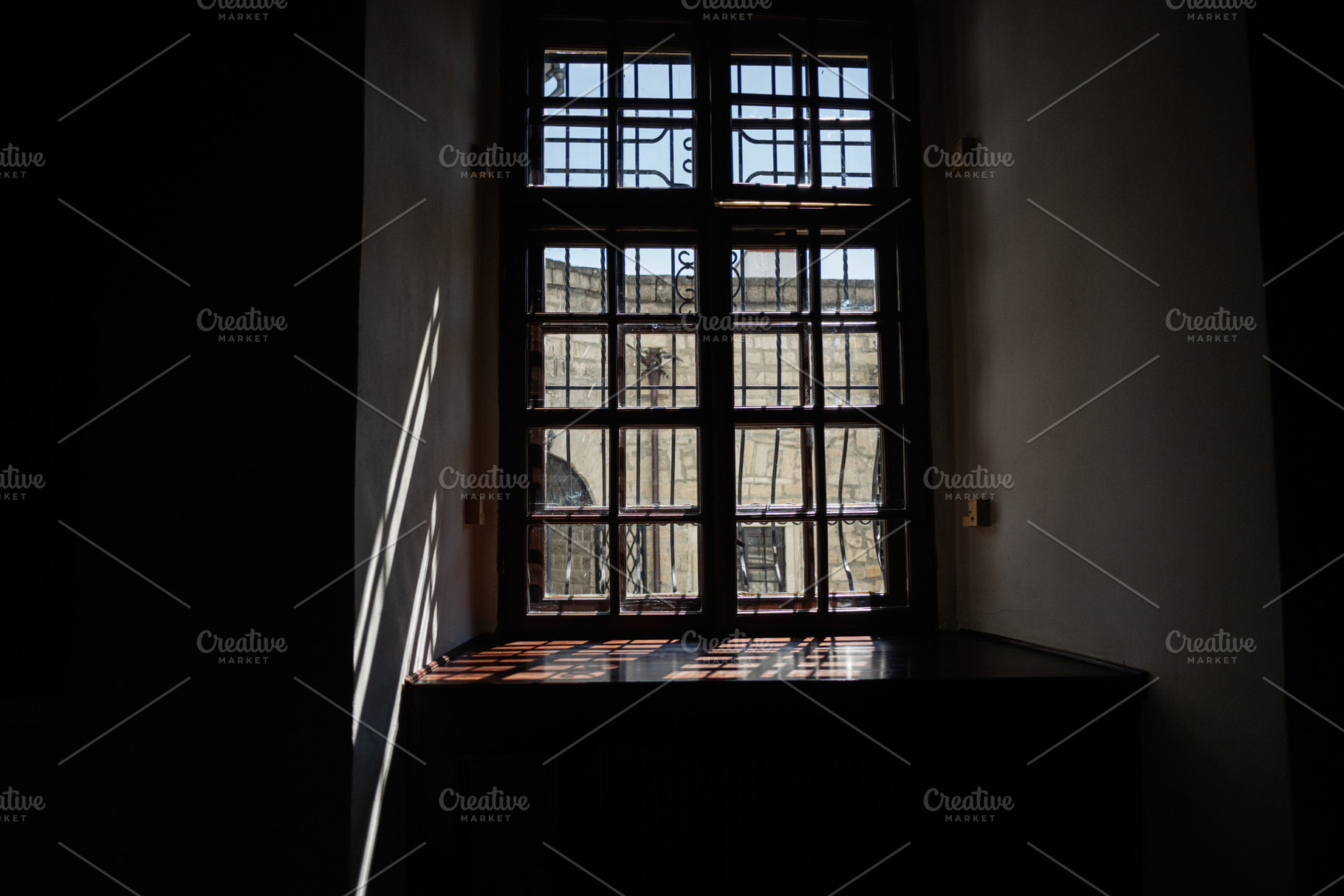 Sunlight streams through a closed wooden window casting intricate shadows indoo, a Photo by AS photostudio