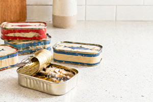 Sardine cans on kitchen counter with, a Photo by Dvoevnore photos