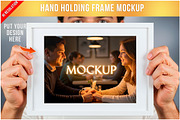 Hand Holding Picture Frame PSD, a Product Mockup by Bruno's Shop (Thumbnail 1 of 3)