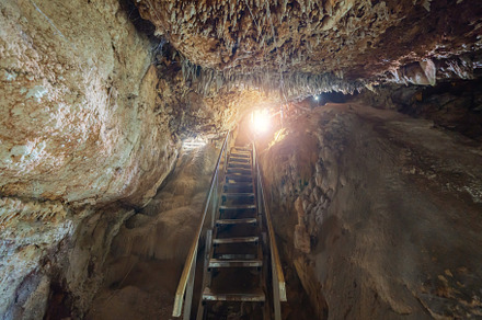 Natural stalactite and stalagmite rock stone cliff hang from cav, a Background Photo by Tampatra
