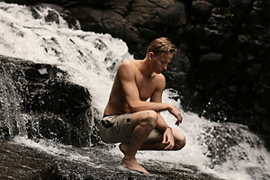 Shirtless Man at Waterfall alone
