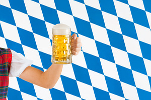 Woman holding beer stein celebrating Oktoberfest in Bavaria, a Food & Drink Photo by Antonio Gravante Market