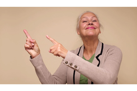 An elderly woman points her finger