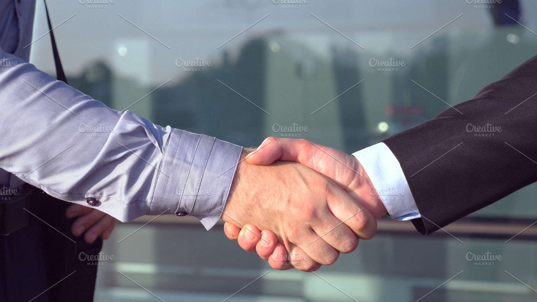 Close up of successful businessmen containing agreement, arm, and building, a Person Photo by Footage Autor
