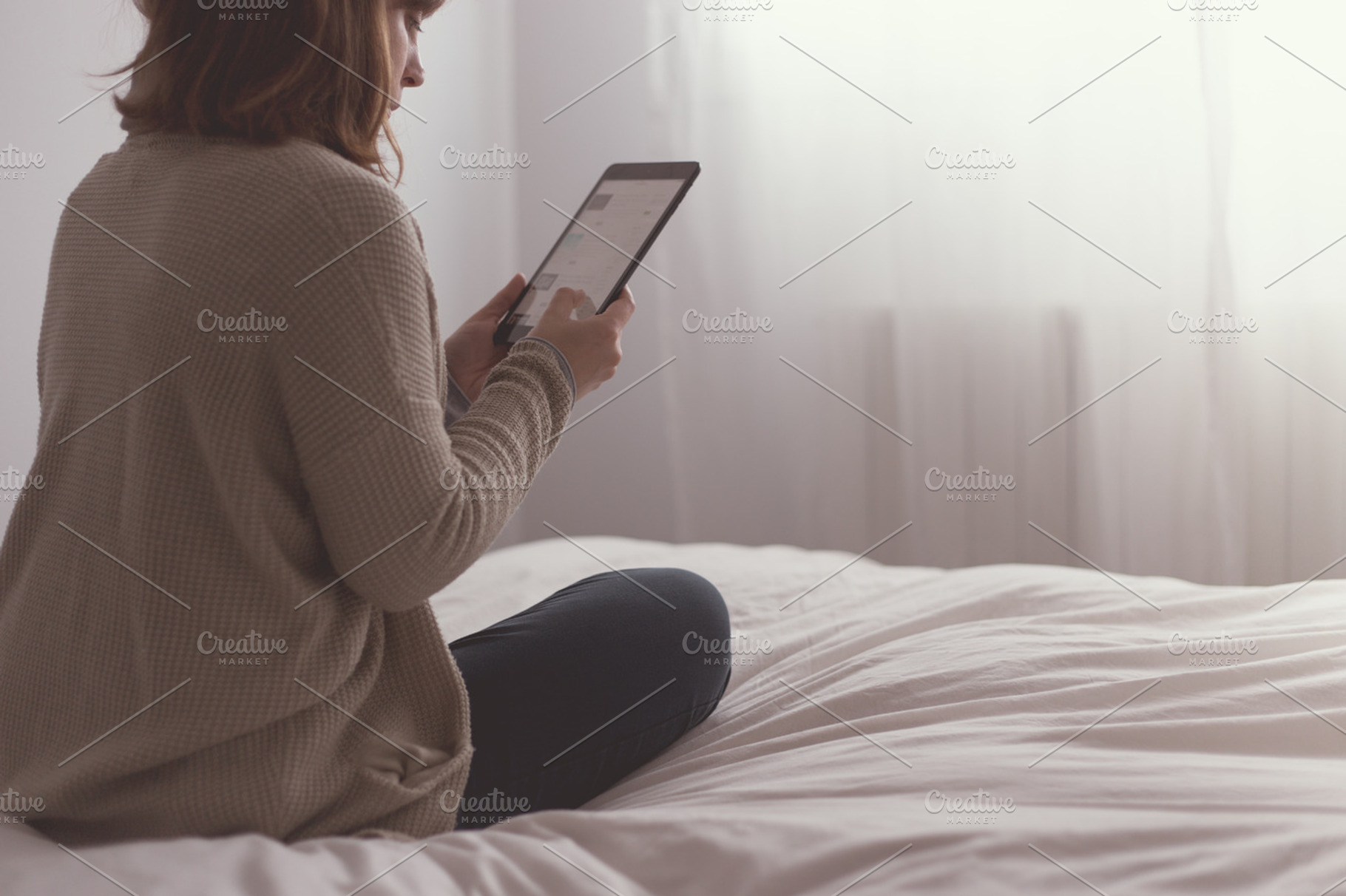 Woman reading on the Ipad, a Person Photo by Tan Tranquila