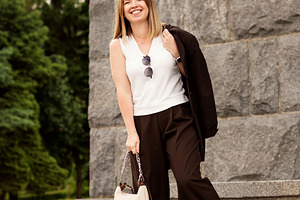 Young woman smiling confidently, a Person Photo by Elena Vagengeim