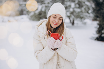Cute happy woman holding hot coffee, a Holiday Photo by Cherkas Photography