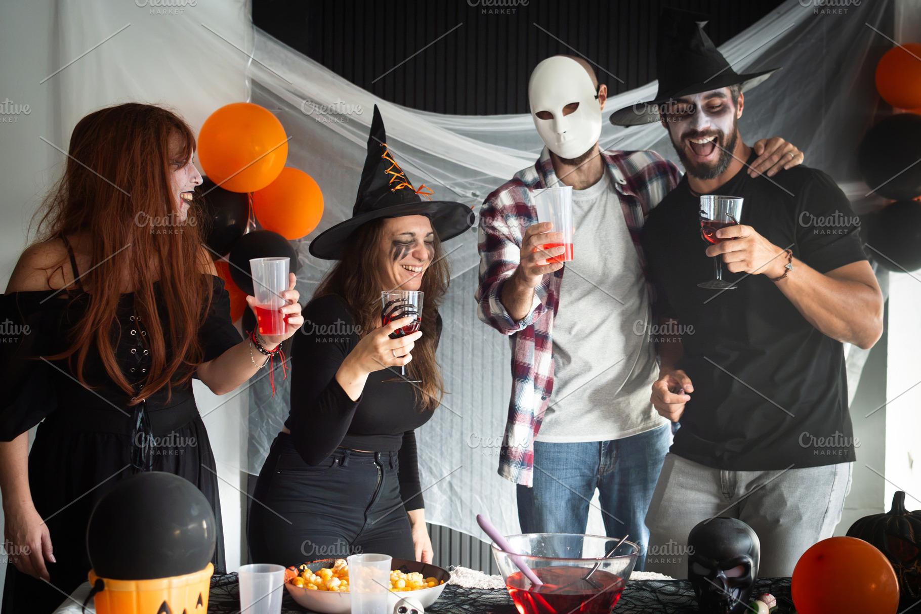 Friends laughing together at a Halloween costume party, a Person Photo by etorres69