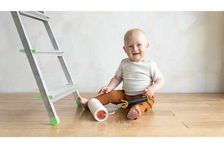 Baby boy with painting roll near