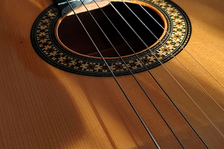 Close-up, high-angle detail shot of a classic spanish guitar, an Arts & Entertainment Photo by DanFLCreativo