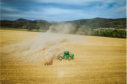 Aerial view of a harvester working, an Industrial Photo by HalfPoint