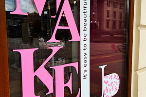 Shopfront showcasing makeup branding with stylish modern design and bold typogr, a Photo by AS photostudio