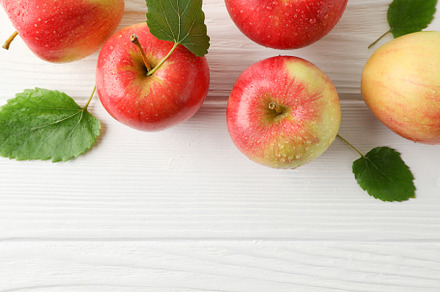 Composition with apples on white wooden background, top view, a Food & Drink Photo by AtlasStudio