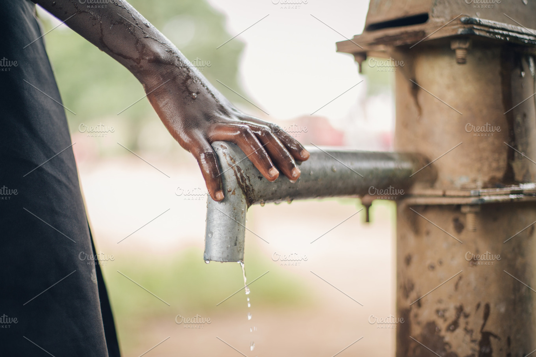 African Child's Hand on Water Spout, an Abstract Photo by Legends Hill