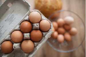 Fresh brown eggs in carton and glass, a Food & Drink Photo by HalfPoint