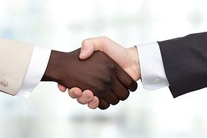 African man hand shaking white man hand, a Business Photo by AlyaAnd