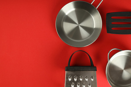 Kitchen utensil on red background, space for text, a Food & Drink Photo by AtlasStudio PRO