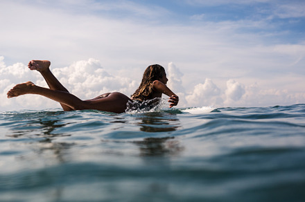 Beautiful young indonesian woman in bikini surfing wave in bali on the, a Sports & Recreation Photo by olsinphoto