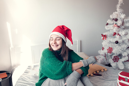 smiling girl wearing a Santa Claus h