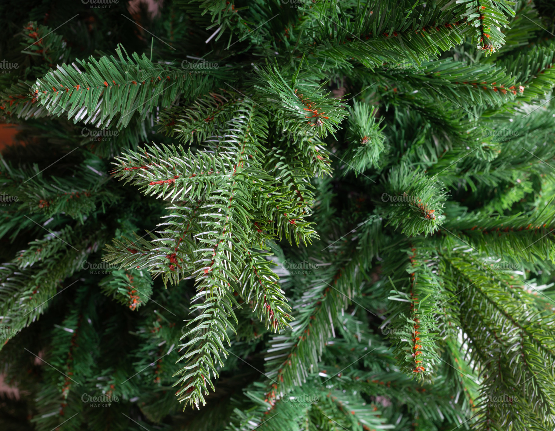 Artificial Christmas tree branches creating a green holiday background, a Holiday Photo by Antonio Gravante Market