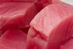A stack of raw tuna pieces on a white board, a Food & Drink Photo by ndanko