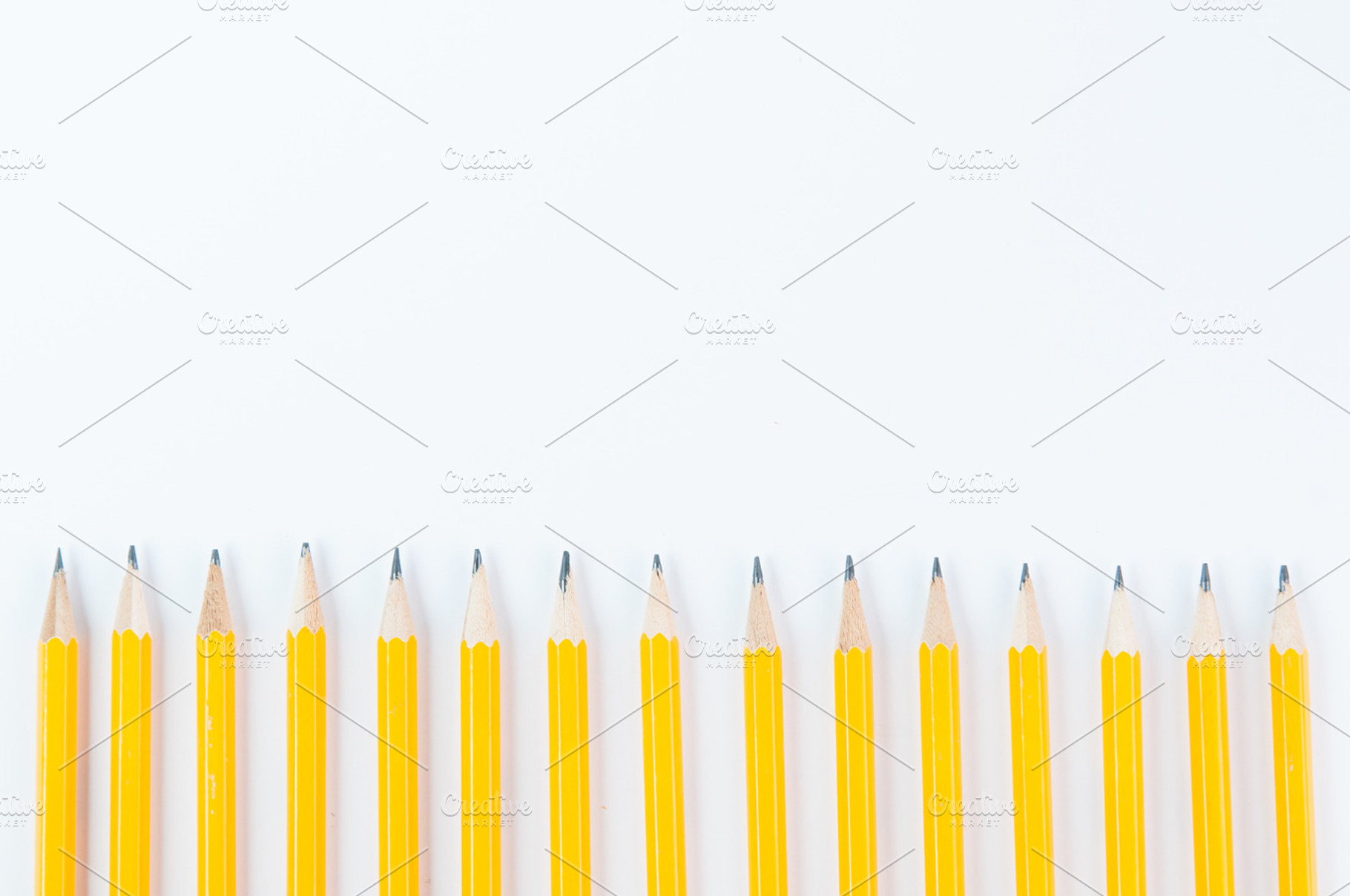 Yellow school pencils containing back to school, copy space, and white, a School & Education Photo by Siân C Photography