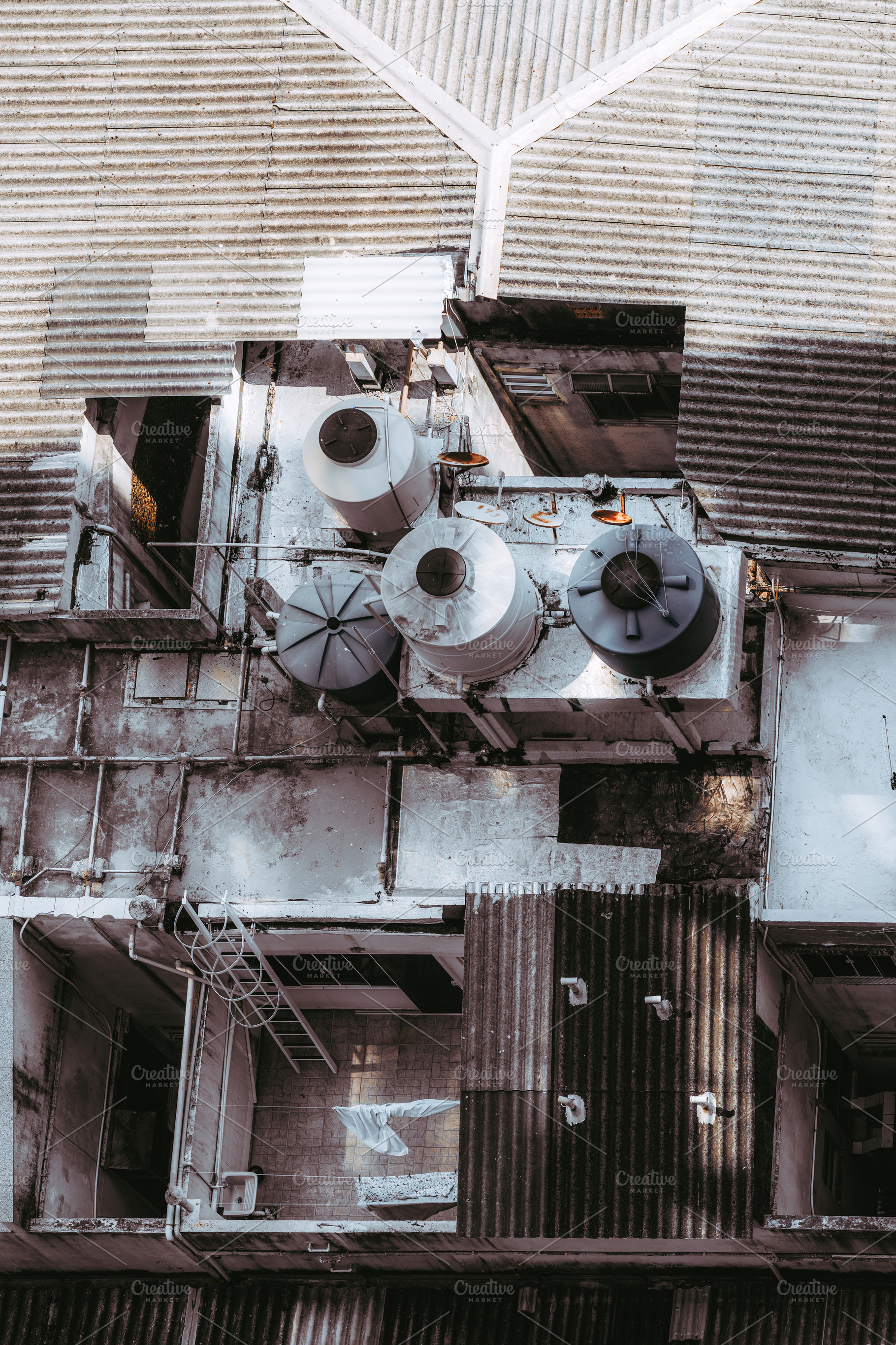 Urban rooftop with water tanks, an Industrial Photo by SkyNext