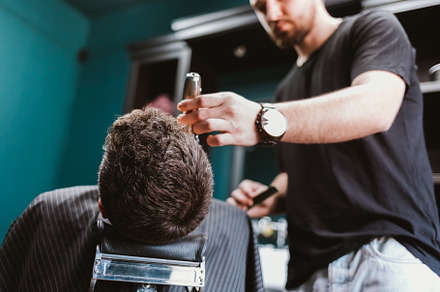 Close-up professional barber doing hair cut, a Person Photo by progressman