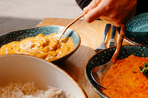 man about to serve some chicken korma, a Photo by Nito
