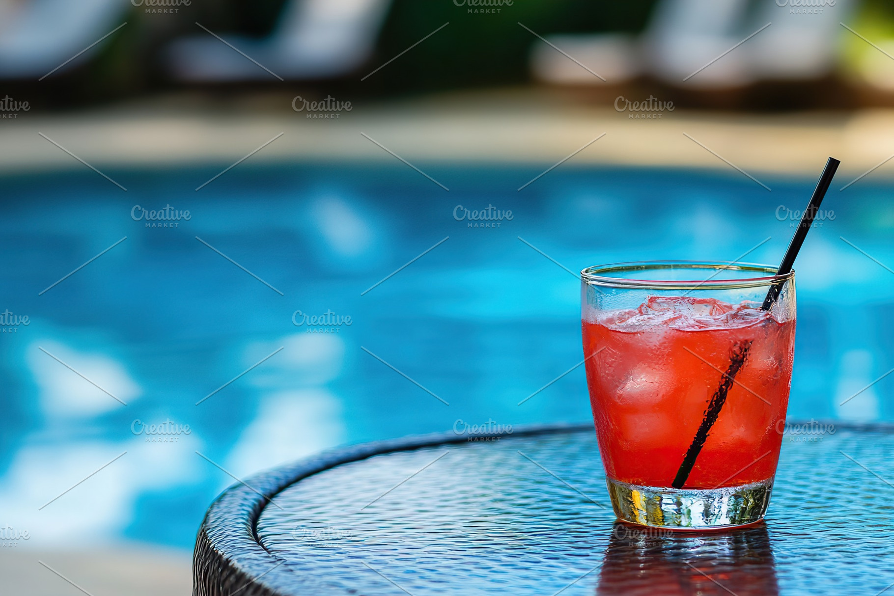 Refreshing cocktail served by a shimmering pool on a sunny day with colorful be, a Food & Drink Photo by AlyaAnd