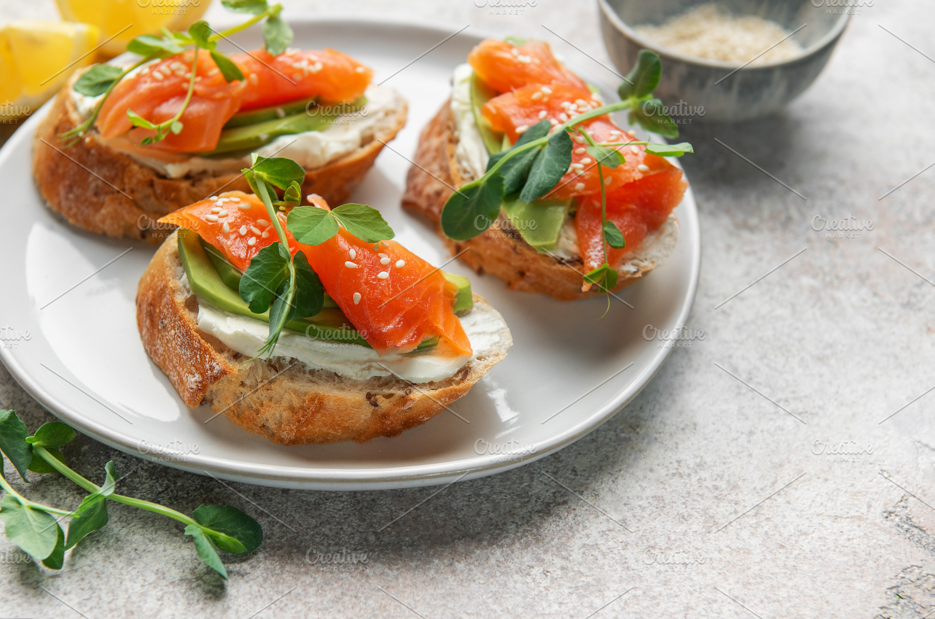 Salmon avocado toasts with microgreens for healthy breakfast, a Food & Drink Photo by Olena Rudo