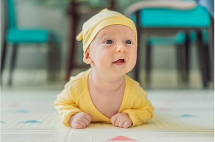 One-month-old baby lying on tummy