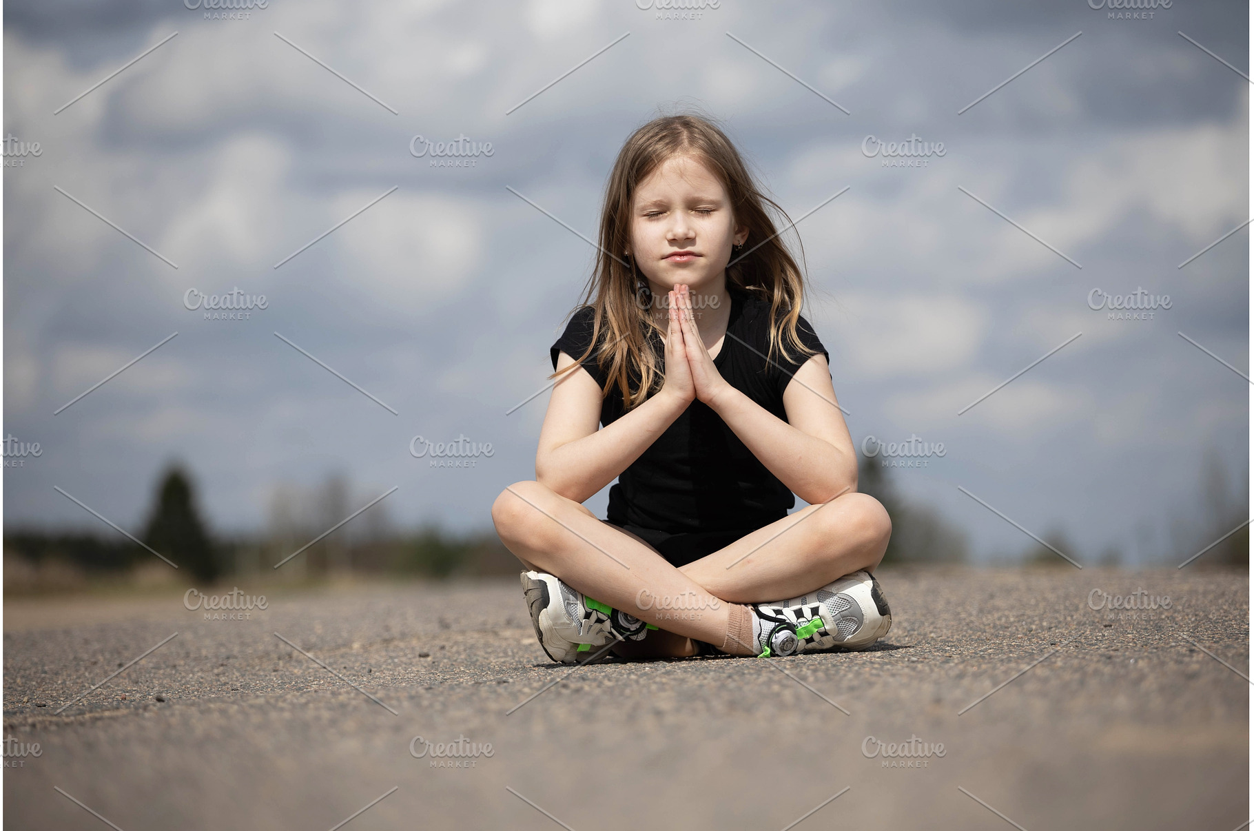 Little beautiful girl praying in, a Person Photo by Nenahliadava Design