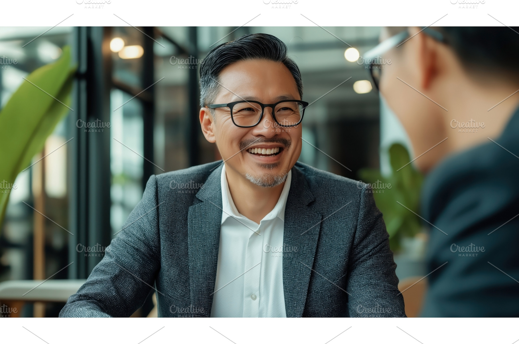 Asian businessman in glasses smiling, a Person Photo by Sergey Kotenev