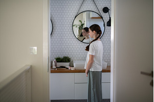 Teenage girl looking at herself in, a Person Photo by HalfPoint