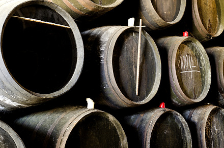 Barrels for whiskey or wine containing wine, whiskey, and barrels