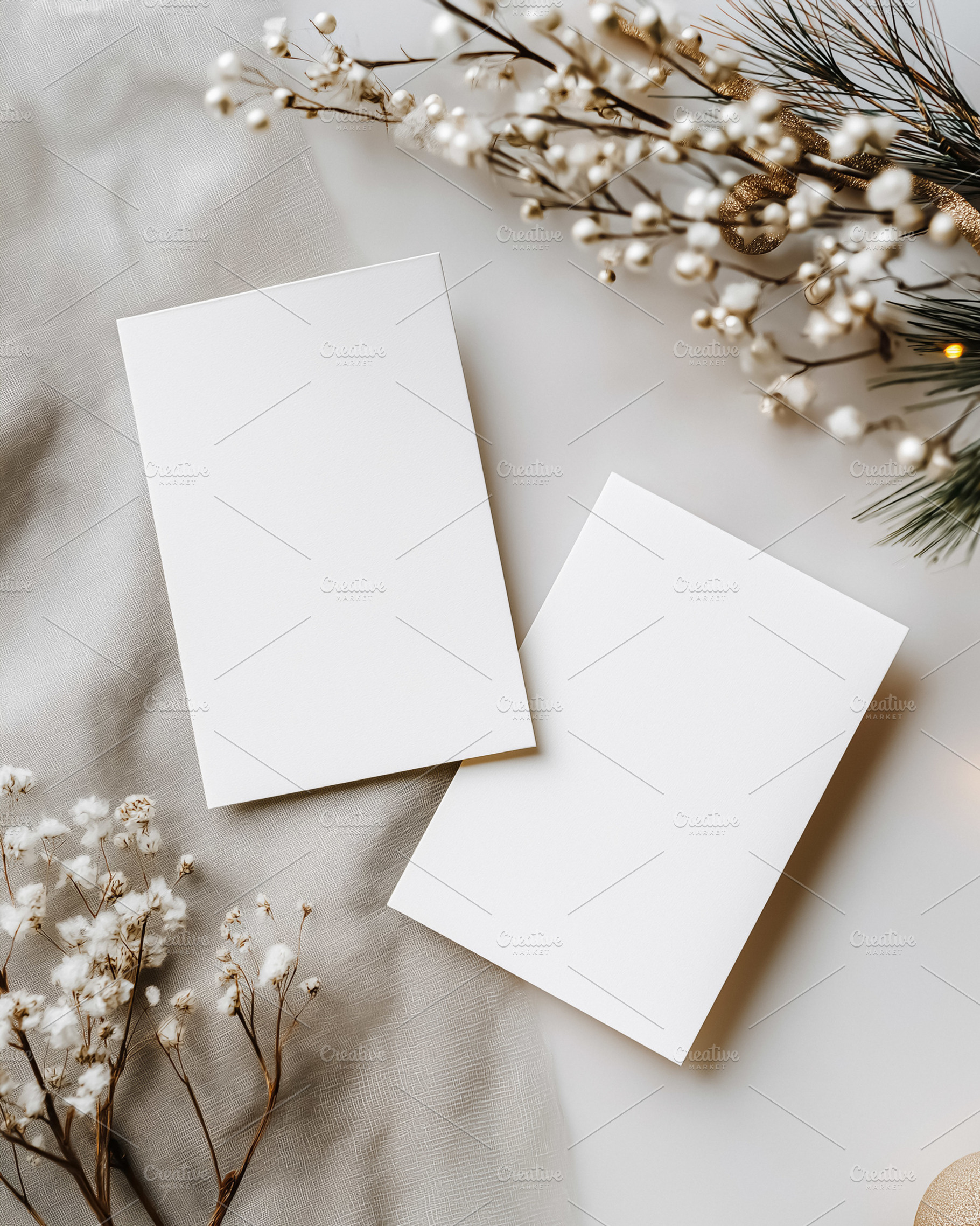 Blank white invitation cards mockup on gray fabric with festive Christmas decor, a Holiday Photo by Studio ANNA