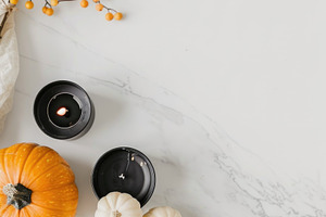 Elegant Halloween flat lay with pumpkins and black candles, a Nature Photo by José Manuel Gelpi