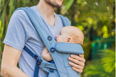Young father walks in nature with