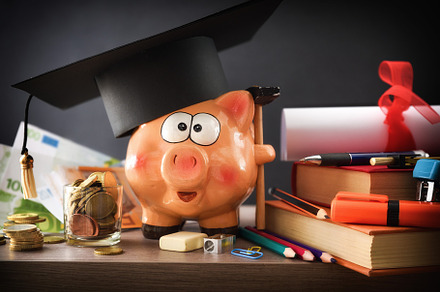 Detail of concept of saving for education with piggy bank