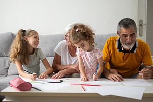 Happy Grandparents Drawing with Their Granddaughters at Home, a Person Photo by etorres69