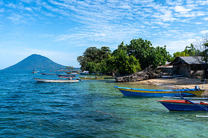 Small port on Bunaken Island Sulawesi Indonesia with volcano vie, a Nature Photo by GoodGoods