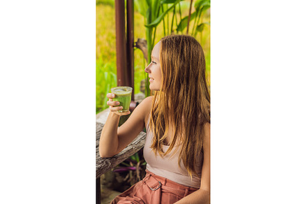 Young woman holding cup of matcha, a Food & Drink Photo by Elizaveta Galitskaya