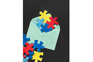 Colorful puzzle pieces spilling out, a Photo by tilialucida