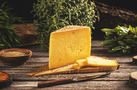 Triangle slices of cheese with rosemary, a Photo by Grafvision photography