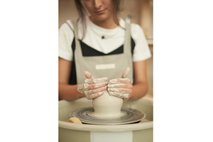 Woman modelling vase on pottery