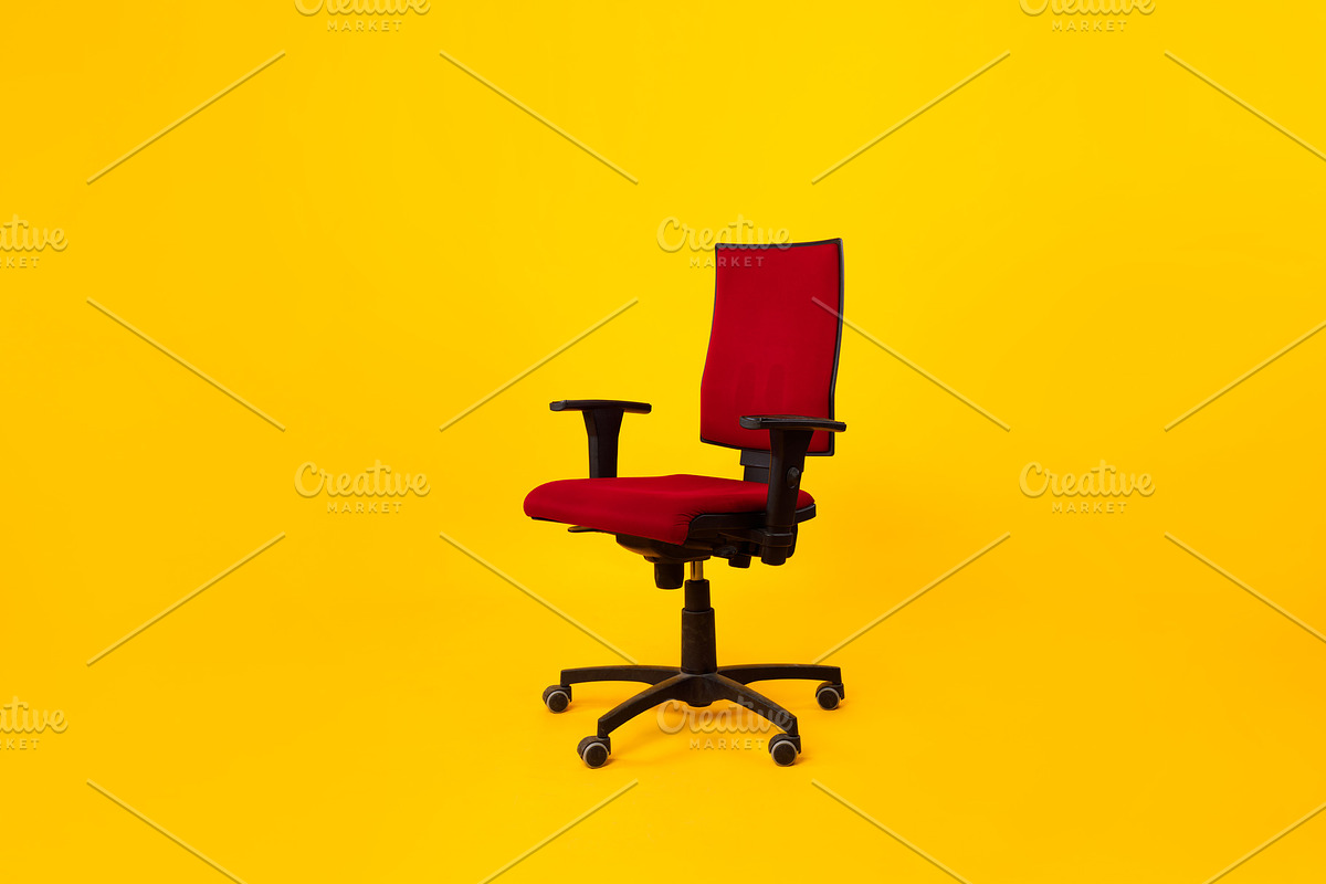 Empty Adjustable Ergonomic Office Chair With Armrests Over Yellow Background, a Photo by Prostock-Studio (Photo 1 of 2)