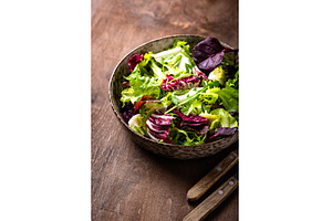 Bowl of fresh green salad mix, a Food & Drink Photo by Yulia Furman